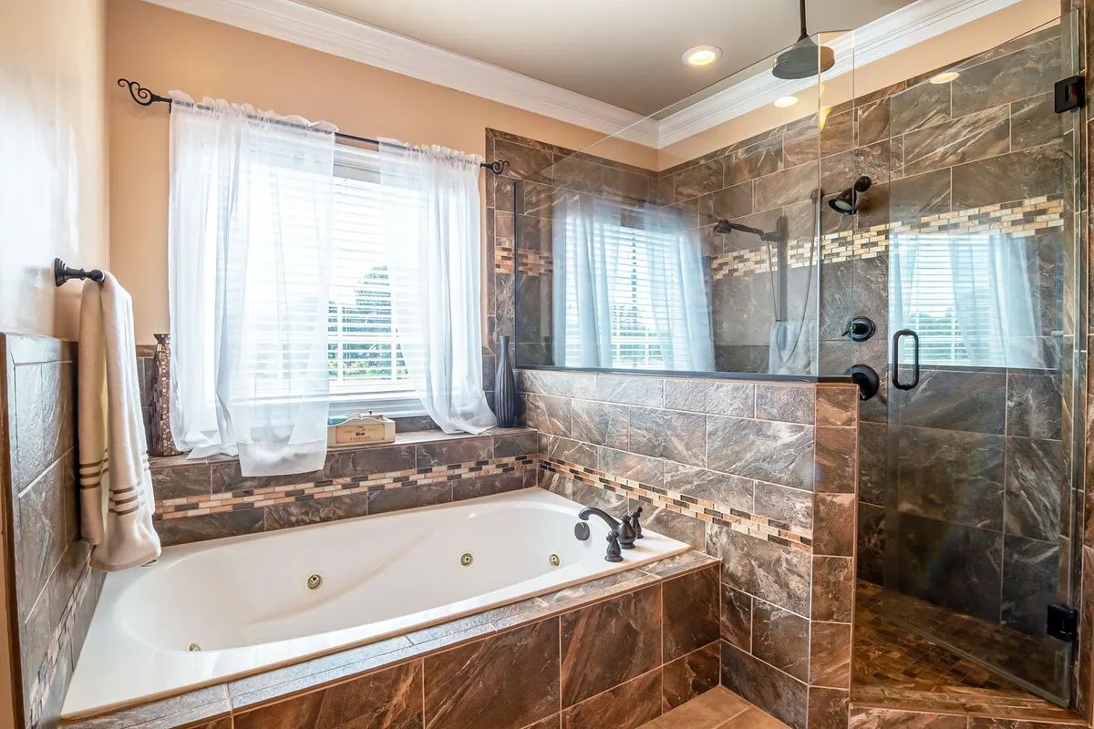 Luxury bathroom with freestanding tub and marble-tiled walk-in shower