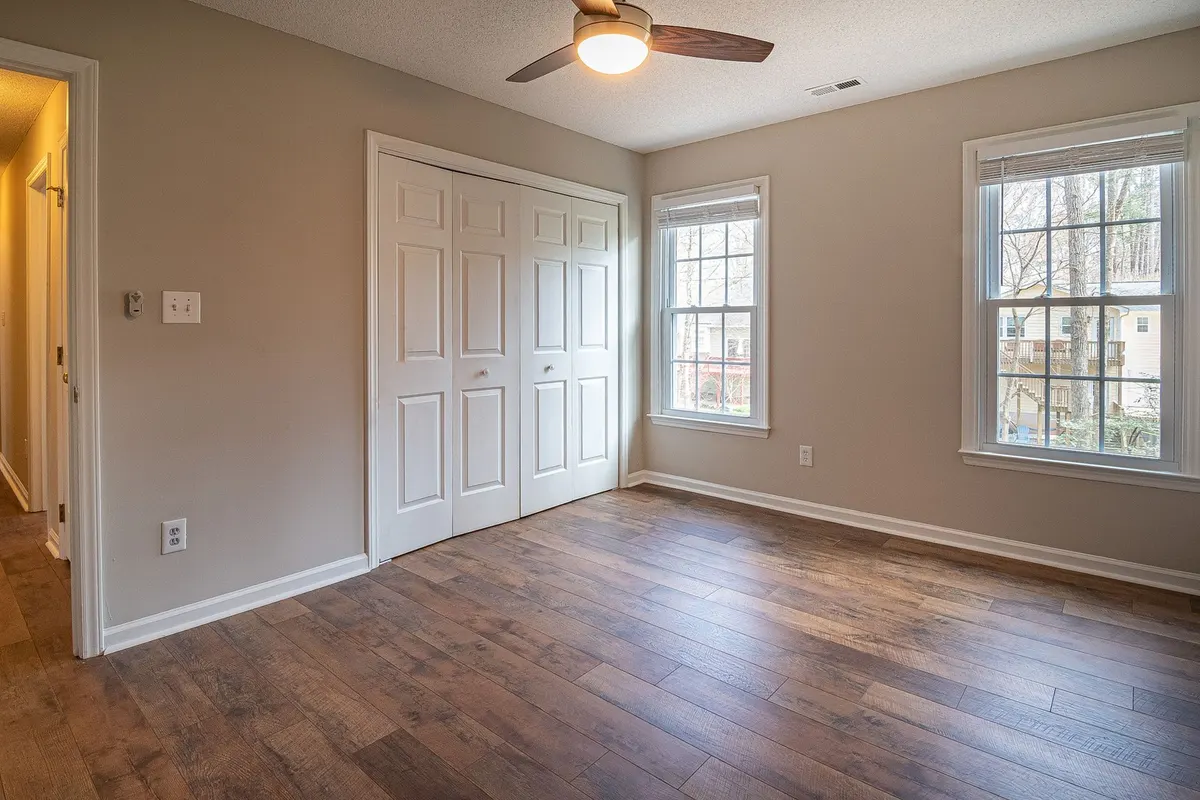 Bright room with wide-plank hardwood flooring and natural window light